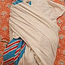 newborn, baby, infant, sleeping, swaddled, blanket, nursery, changing_pad, portrait, face, eyes_closed, peaceful, hospital_blanket, patterned_surface, caregiver_supplies, tissue_box, medical_setting, indoor, photography, resting