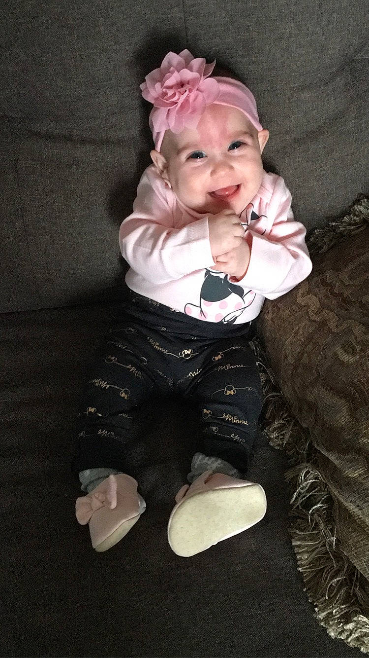 Harper joined the competition — help win amazing prizes! baby, baby_toddler_clothing, cheek, child, comfort, eye, face, flash_photography, flower, head, headpiece, human_body, iris, pattern, sitting, sleeve, smile, sock, toddler, wood