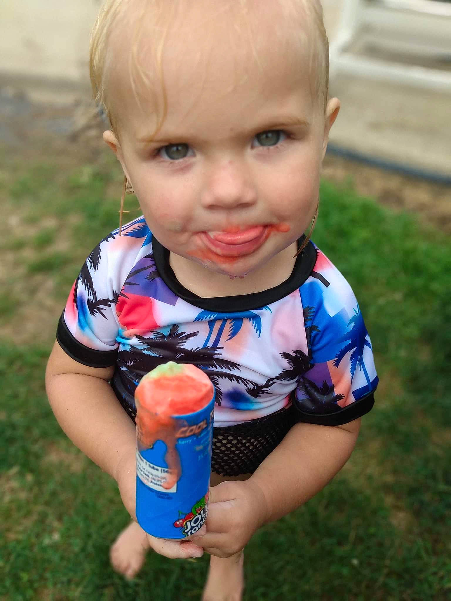 Charlie is registered to the contest to win money with this photo: baby, baby_toddler_clothing, child, drink, drinking, electric_blue, fun, grass, happy, people_in_nature, person, play, portrait_photography, recreation, sitting, t_shirt, thumb, toddler, vacation, water