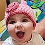 baby, child, infant, smiling, open_mouth, pink_hat, crocheted_hat, big_eyes, long_eyelashes, cute, tongue, teeth, closeup, portrait, happy, indoor, blanket, bedroom, person, arm