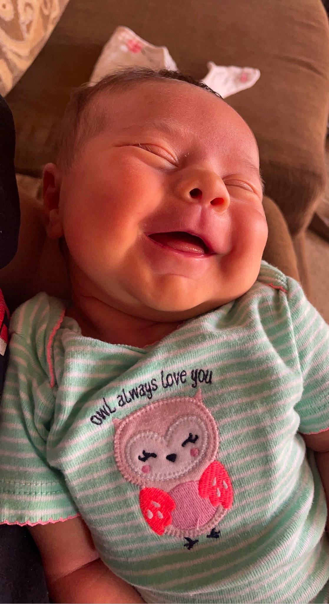 Lucy is registered to the contest to win money with this photo: baby, baby_toddler_clothing, cheek, chin, facial_expression, forehead, happy, human, lip, mammal, mouth, neck, nose, organ, person, pink, product, skin, sleeve, smile