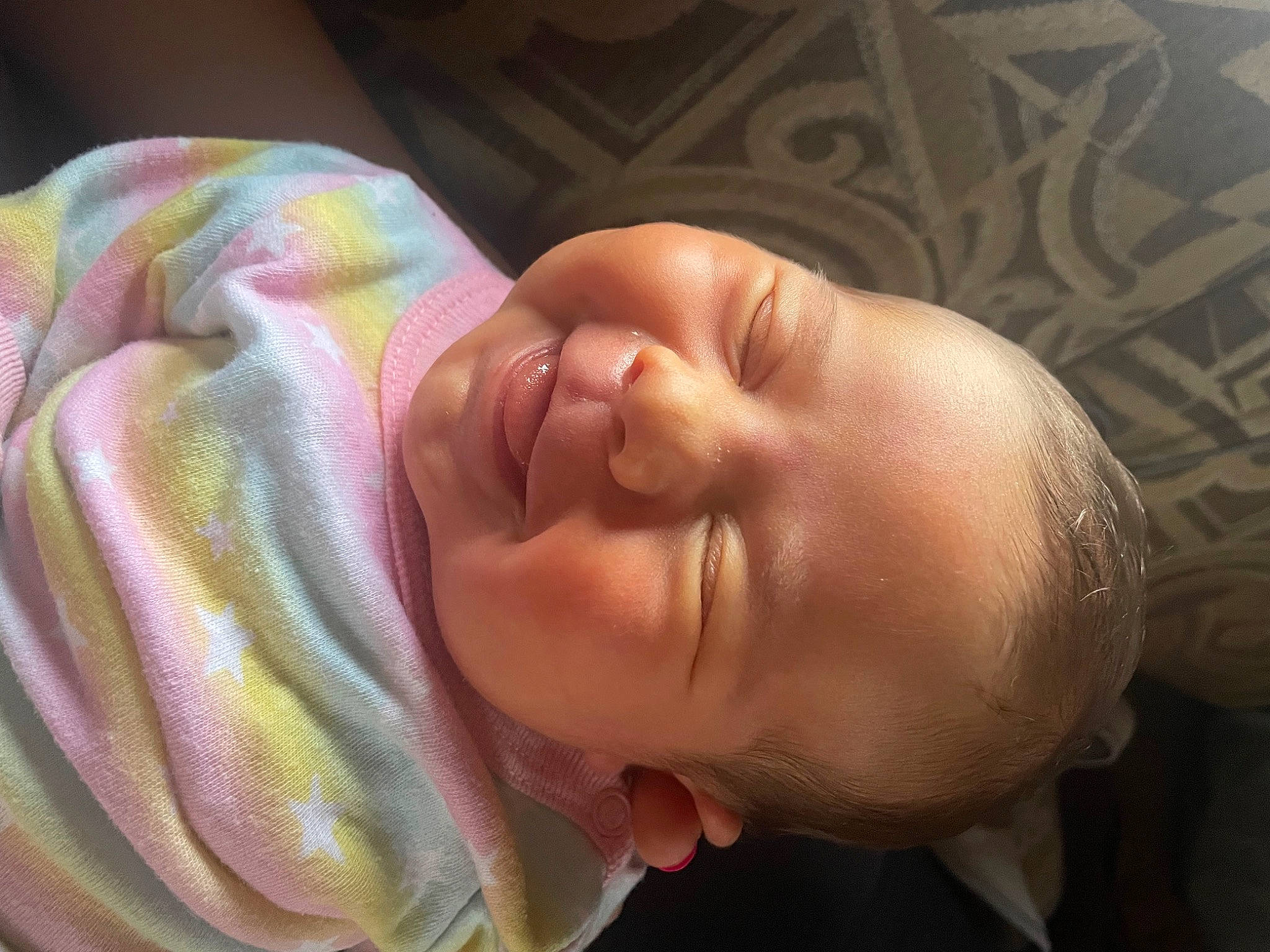 Lucy is registered to the contest to win money with this photo: arm, baby, baby_toddler_clothing, cheek, ear, eye, eyebrow, face, gesture, hand, head, headgear, human_body, iris, lip, nail, neck, nose, person, thumb