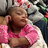 baby, sleeping, pink_clothing, blanket, indoor, dog, pet, resting, cute, child, cozy, soft, portrait, relaxation, furniture, home, animal, peaceful, napping, infant