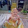 baby, blanket, chair, child, colorful, cute, decor, dress, floor, happy, headband, indoors, pastel_colors, person, room, sitting, smiling, soft_focus, toddler, toys