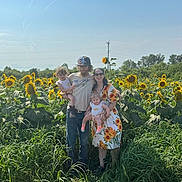 Paige joined the competition — help win amazing prizes! family, child, baby, sunflower_field, outdoor, nature, grass, sunflower, adult, man, woman, casual_clothing, hat, glasses, smile, happy, summer, daylight, plants, portrait
