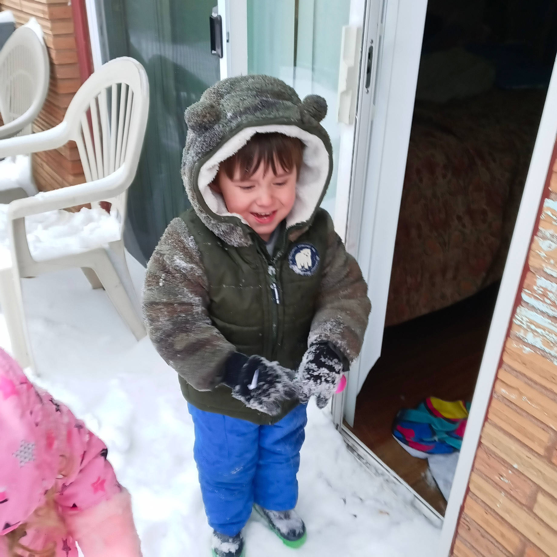 Ryder is registered to the contest to win money with this photo: chair, child, clothing, event, freezing, fun, glove, headwear, hood, hoodie, house, joy, leisure, person, playing_in_the_snow, recreation, sitting, smile, snow, snow_boot