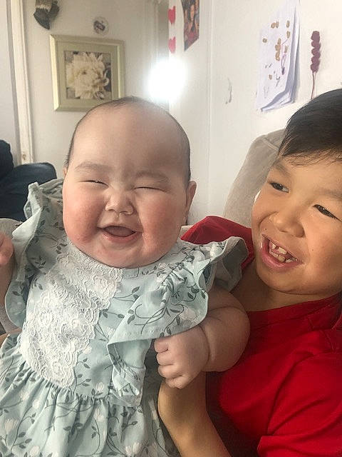 Christina joined the competition — help win amazing prizes! baby_toddler_clothing, cheek, chin, ear, eye, eyebrow, facial_expression, finger, gesture, happy, head, interaction, iris, lip, mouth, neck, nose, person, picture_frame, skin