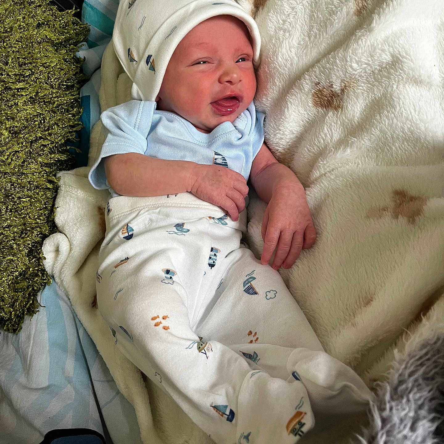 Oliver joined the competition — help win amazing prizes! baby, bed, blanket, clothing, comfort, cozy, cute, expression, face, hand, hat, indoors, infant, lying_down, newborn, pajamas, person, sleepwear, small, soft