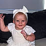baby, baby_girl, bow, child, couch, cute, eyebrows, foot, furniture, hand, happy, headband, indoors, infant, person, portrait, sitting, skin, smiling, white_dress