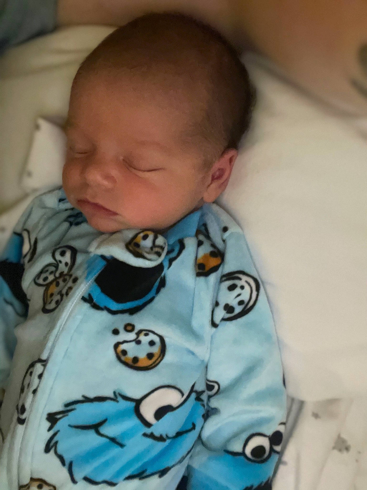 Isaac is registered to the contest to win money with this photo: baby, baby_toddler_clothing, cheek, chin, collar, comfort, ear, eye, eyebrow, finger, head, iris, mouth, neck, nose, person, skin, sleeve, t_shirt, textile