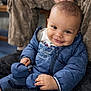 baby, blue_jacket, candid, casual, child, closeup, cozy, cute, face, hand, happy, human, indoor, infant, person, portrait, seated, smile, warm_clothing, young_child