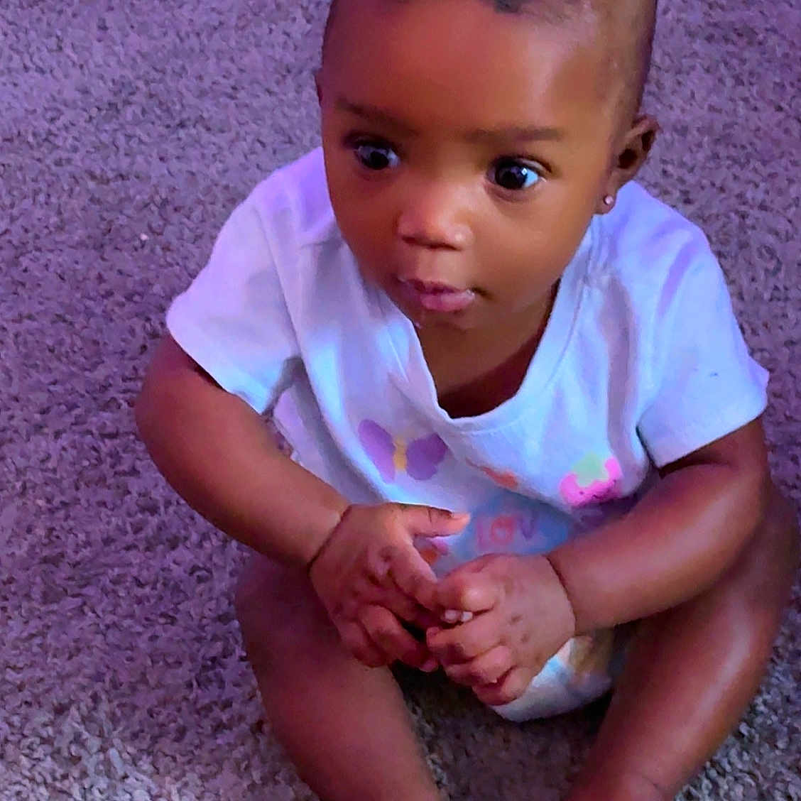 Blossom joined the competition — help win amazing prizes! baby, child, infant, sitting, carpet, curious, wide_eyes, white_shirt, pink_bow, hands, feet, indoors, cute, portrait, person, toddler, skin, expression, clothing, floor