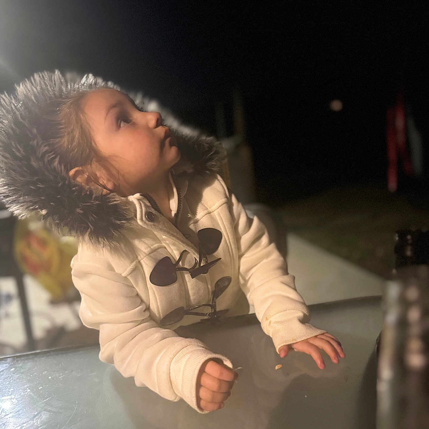 Deychanel joined the competition — help win amazing prizes! baby, bodypart, city, clothing, coat, face, finger, hand, happy, head, jacket, outdoors, performer, person, photography, portrait, sitting, smile, soloperformance, urban