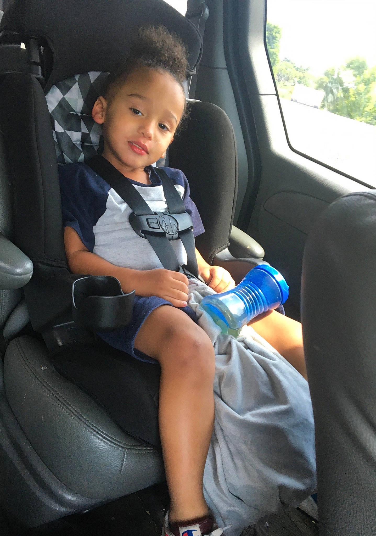 Kobe joined the competition — help win amazing prizes! automotive_design, automotive_exterior, car, car_seat, car_seat_cover, comfort, head_restraint, leg, mode_of_transport, motor_vehicle, person, plant, seat_belt, smile, sneakers, steering_part, steering_wheel, toddler, vehicle, vehicle_door