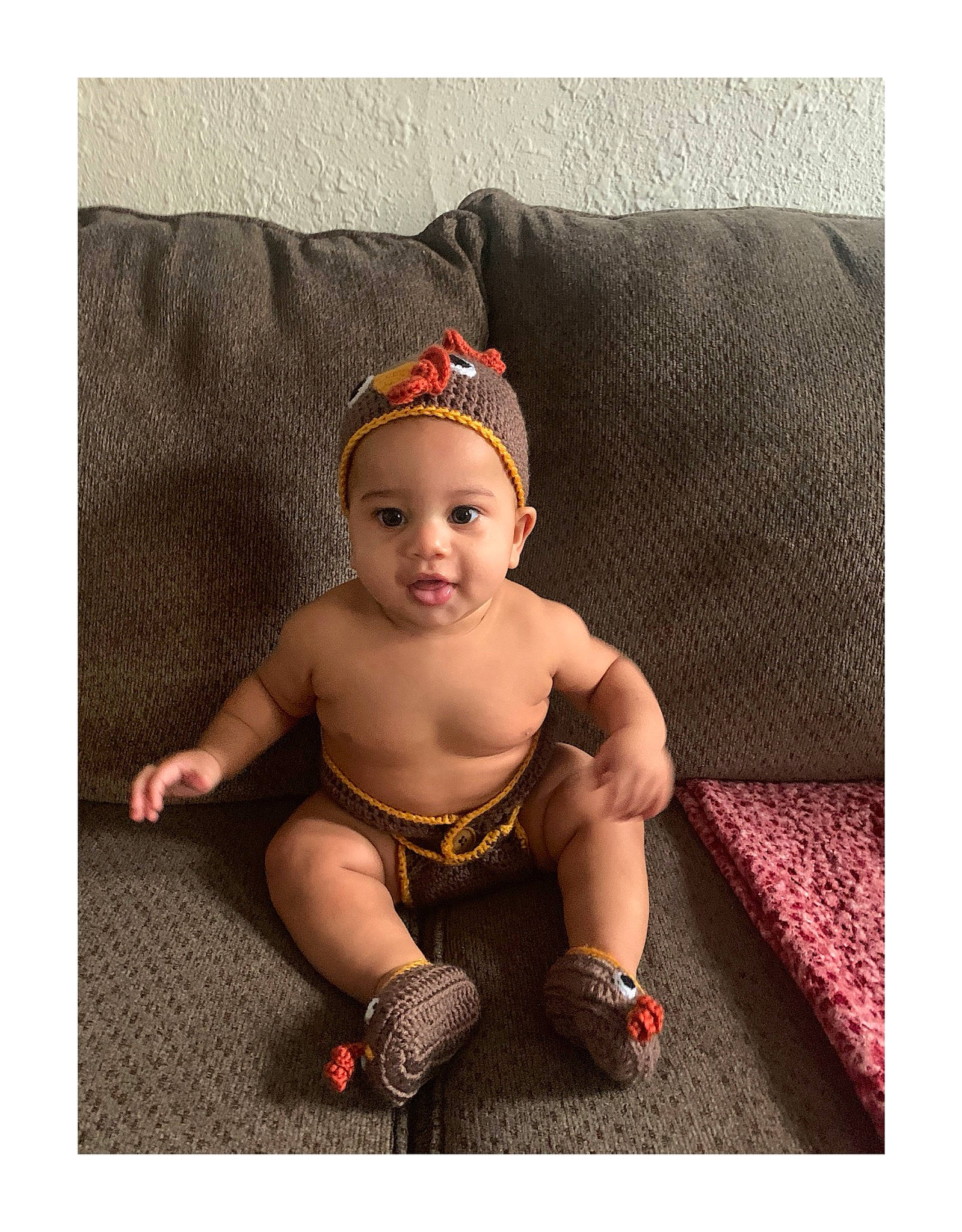 Jakobe joined the competition — help win amazing prizes! baby, baby_toddler_clothing, cap, child, comfort, costume_hat, couch, fashion_accessory, foot, grass, happy, headband, human_leg, knee, person, rectangle, sitting, sleeve, smile, sock