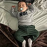 baby, bed, blanket, child, clothing, cozy, cute, green_pants, indoor, infant, pacifier, peaceful, person, pillow, portrait, relaxation, rest, sleeping, sweater, white_socks