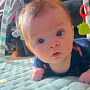 Angel joined the competition — help win amazing prizes! baby, infant, tummy_time, quilted_mat, toy, hanging_toy, curious, wide_eyes, indoor, child, soft_lighting, blue_clothing, cute, face, expression, early_morning_light, hand, floor, playtime, home