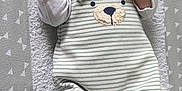 Noah participe au concours pour gagner de l'argent avec cette photo : baby, newborn, sleeping, onesie, hat, socks, blanket, striped_clothing, soft_texture, hand, face, infant, cute, cozy, lying_down, peaceful, child, portrait, indoors, sleep
