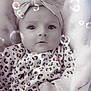 baby, child, headband, bow, leopard_print, blanket, bubbles, infant, clothing, cute, face, portrait, soft_texture, young_child, sitting, looking_up, indoors, cozy, expression, wrapped