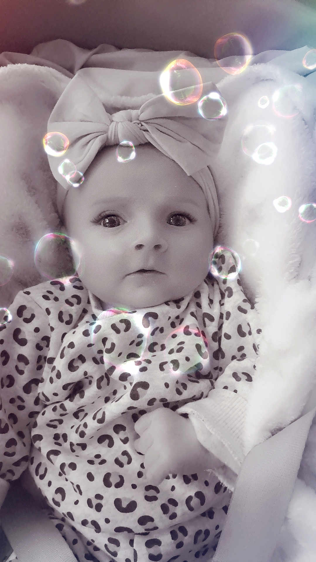 Jade a rejoint le concours — aidez-le/la à gagner de superbes lots ! baby, child, headband, bow, leopard_print, blanket, bubbles, infant, clothing, cute, face, portrait, soft_texture, young_child, sitting, looking_up, indoors, cozy, expression, wrapped