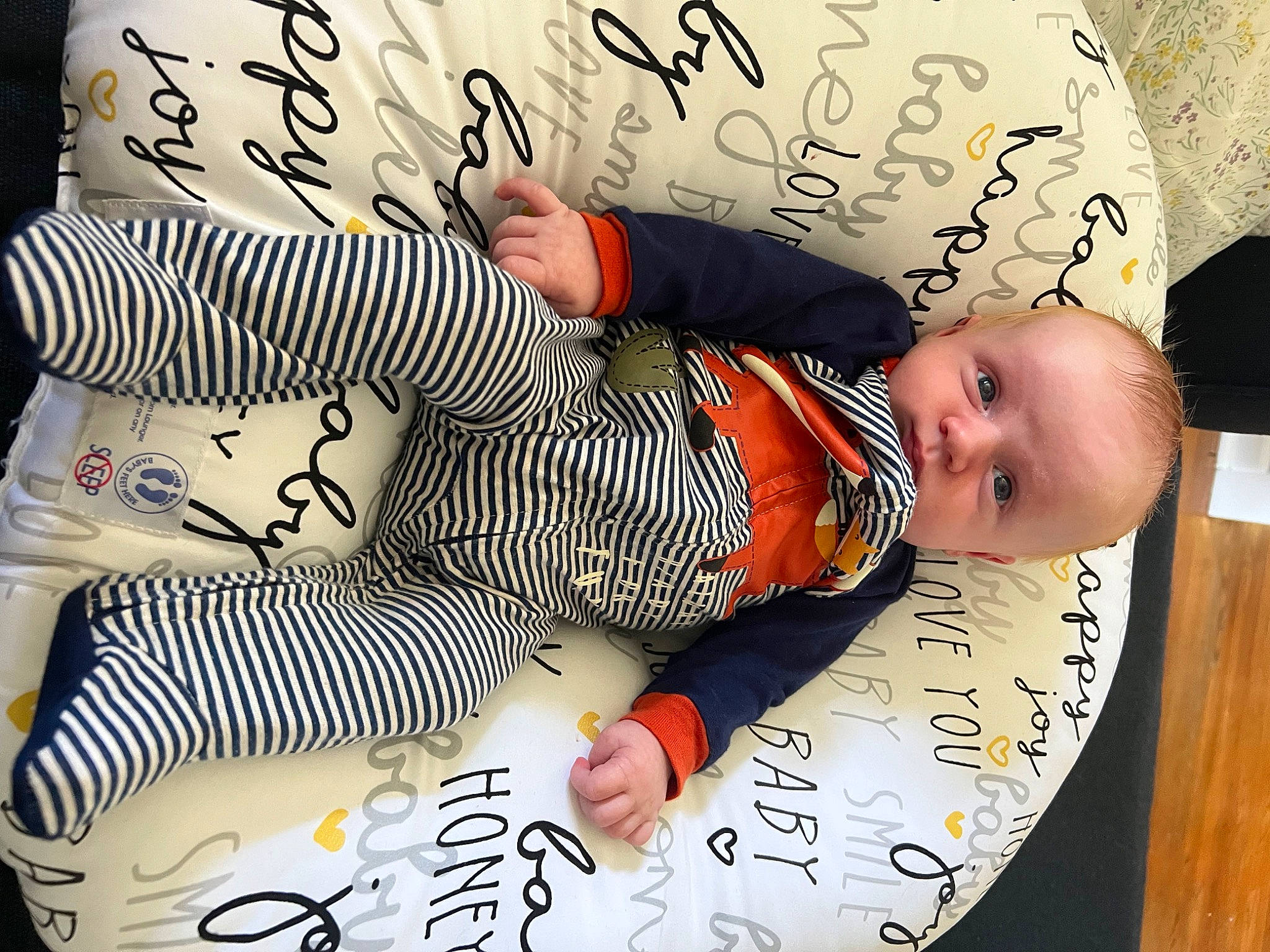 Cashel is registered to the contest to win money with this photo: baby, baby_toddler_clothing, carmine, child, comfort, finger, font, hand, happy, linens, nail, pattern, person, product, sleeve, textile, toddler, white