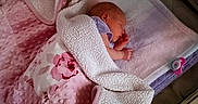 Rayne is registered to the contest to win money with this photo: baby, blanket, child, cozy, cute, fleece, floral_pattern, indoors, infant, newborn, nursery, pacifier, pastel, peaceful, pink, playpen, resting, sleeping, soft_texture, towel