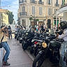 Bérénice participe au concours pour gagner de l'argent avec cette photo : boots, building, casual_clothing, crowd, daytime, dog, helmet, jeans, motorcycle, pedestrian, person, photographer, sidewalk, sign, street, traffic, tree, urban, vehicle, window