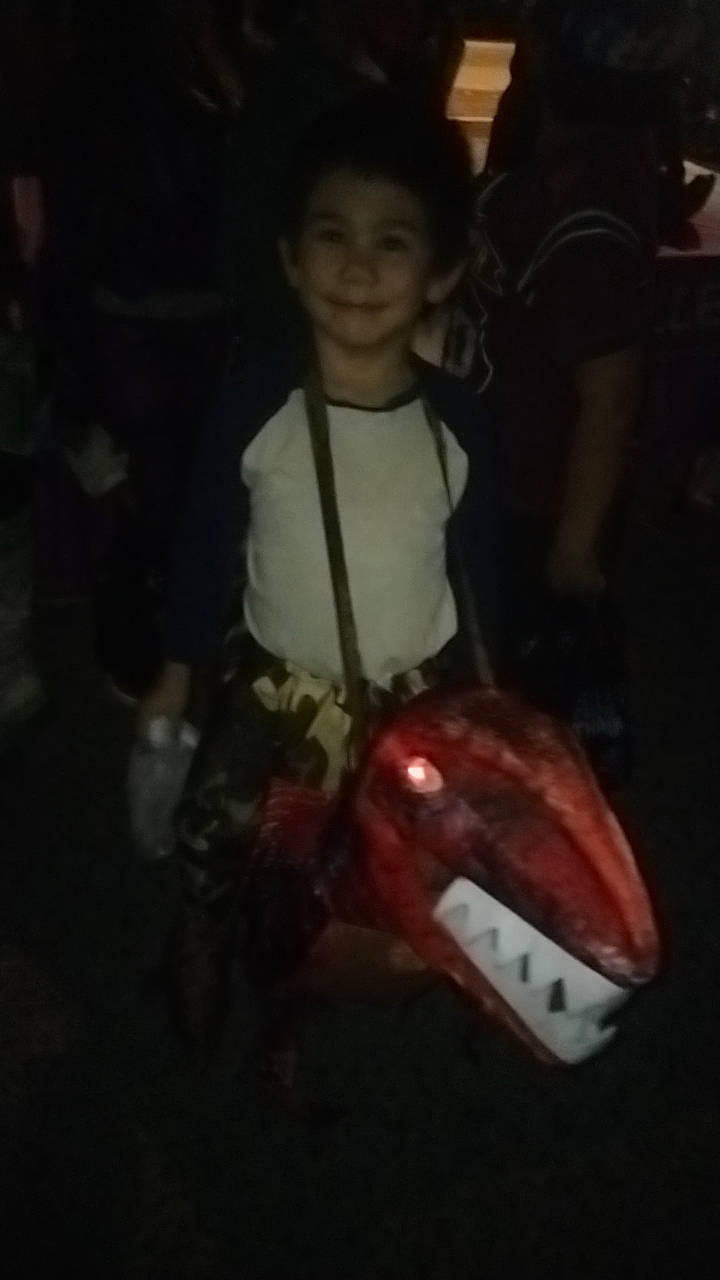 Julian joined the competition — help win amazing prizes! automotive_lighting, bumper, carmine, child, darkness, event, fictional_character, flash_photography, flesh, fun, happy, joy, night, person, personal_protective_equipment, room, shorts, sitting, sleeve, smile