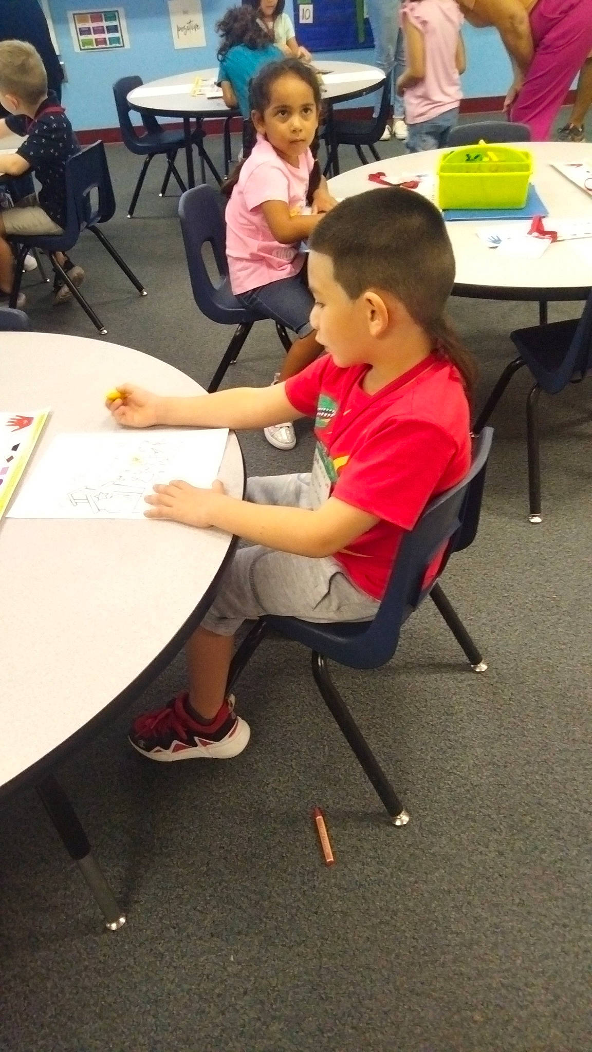 Julian is registered to the contest to win money with this photo: black, chair, child, class, conversation, education, event, fun, furniture, job, learning, leisure, person, recreation, room, sharing, shoe, shorts, social_group, t_shirt