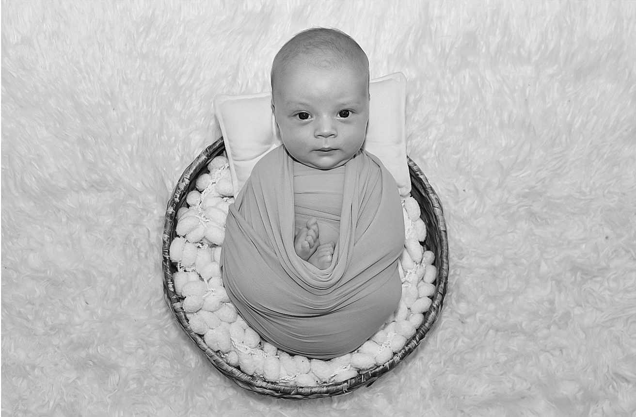 Antony is registered to the contest to win money with this photo: baby, infant, basket, blanket, swaddle, pillow, face, portrait, newborn, soft_texture, black_and_white, cute, cozy, wrapped, lying_down, small_feet, looking_at_camera, studio_shot, child, peaceful