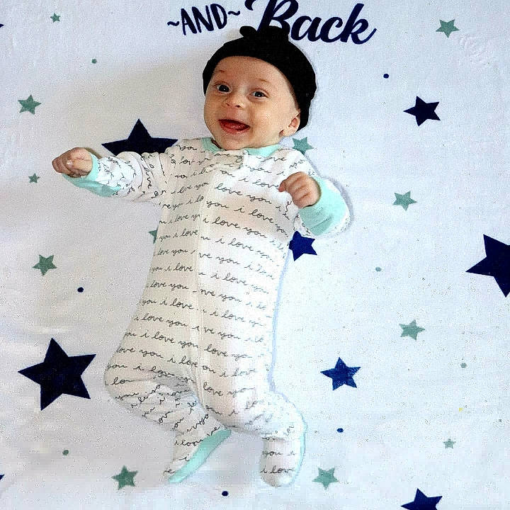 Xavier is registered to the contest to win money with this photo: art, azure, baby, baby_toddler_clothing, beauty, creative_arts, face, finger, gesture, hand, happy, headwear, outerwear, pattern, people_in_nature, person, product, sleeve, smile, textile