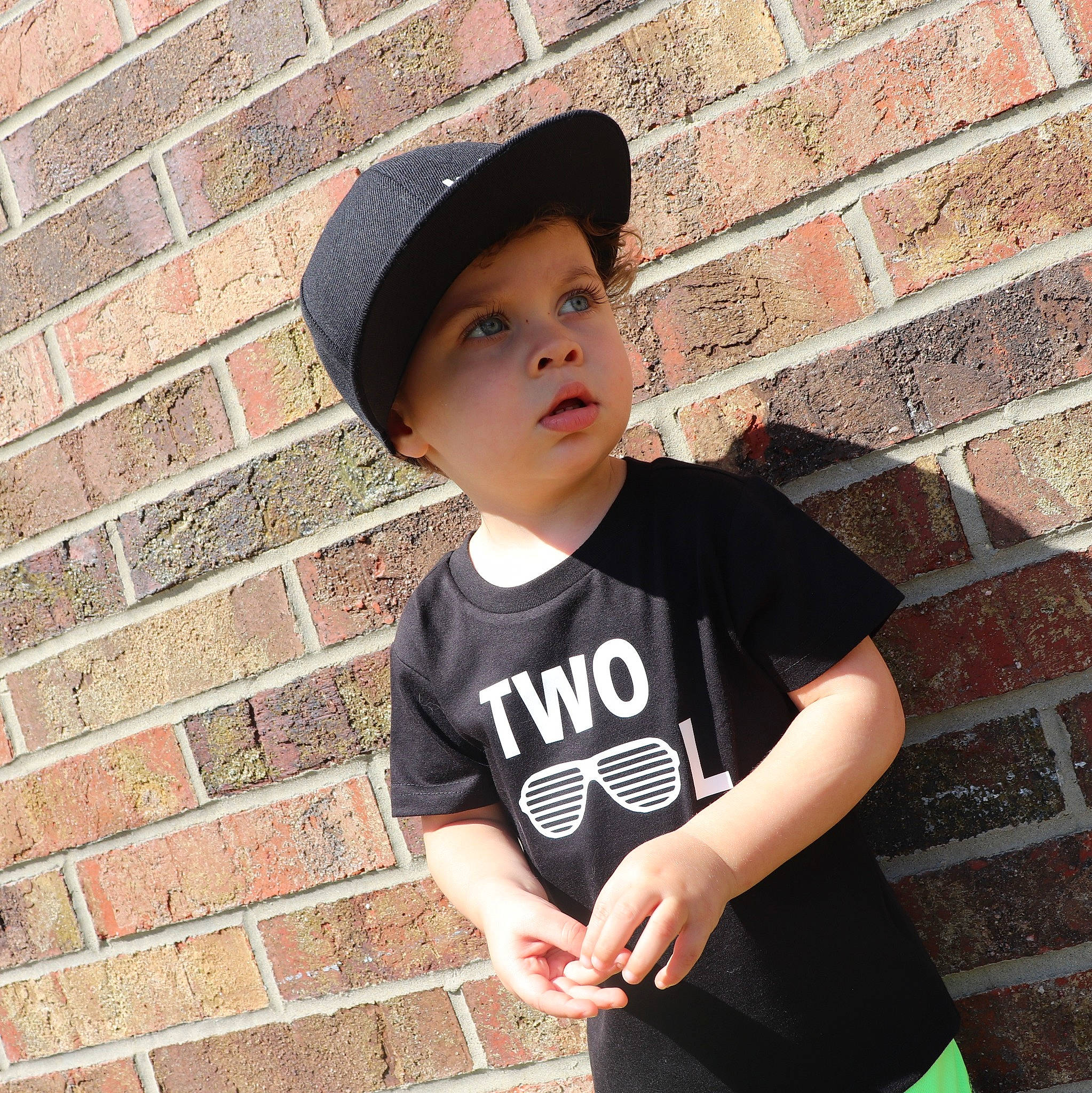 Xavier joined the competition — help win amazing prizes! beauty, black_hair, brick, brickwork, cap, cool, elbow, face, fashion_accessory, flash_photography, happy, hat, headgear, headwear, neck, pattern, person, sleeve, standing, t_shirt