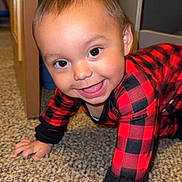 Evelyn is registered to the contest to win money with this photo: black_clothing, carpet, checkered_pattern, child, crawling, cute, face, floor, furniture, hands, happy, home, indoor, person, playful, red_clothing, smiling, storage_bin, toddler, young_child