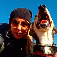 Sofia participe au concours pour gagner de l'argent avec cette photo : beanie, canine, casual, closeup, collar, daylight, dog, friendship, happy, jacket, nature, outdoor, pet, portrait, selfie, sky, smile, sunglasses, sunny, woman