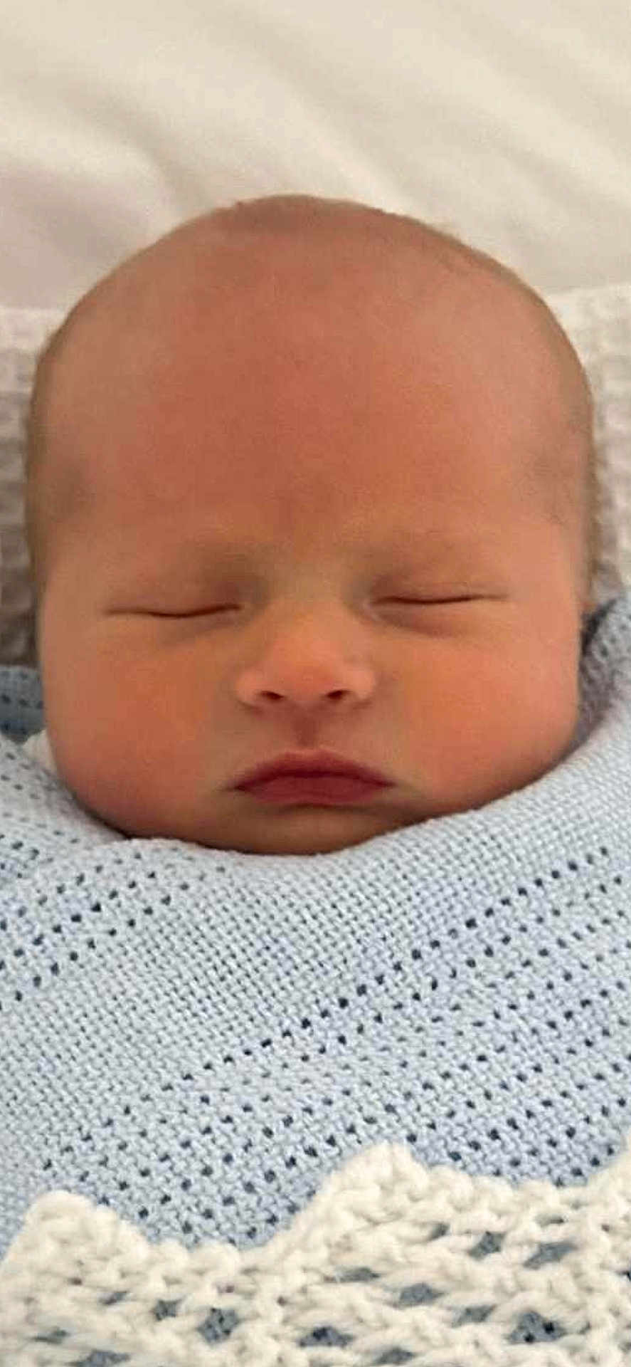 Noa is registered to the contest to win money with this photo: baby, newborn, sleeping, blanket, knitted, blue, infant, face, peaceful, cute, child, portrait, wrapped, soft, closeup, head, skin, calm, resting, adorable