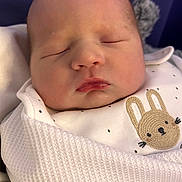 Noa is registered to the contest to win money with this photo: baby, newborn, sleeping, blanket, white, face, infant, cute, bunny, clothing, soft, adorable, peaceful, wrapped, portrait, closeup, child, young, resting, indoors