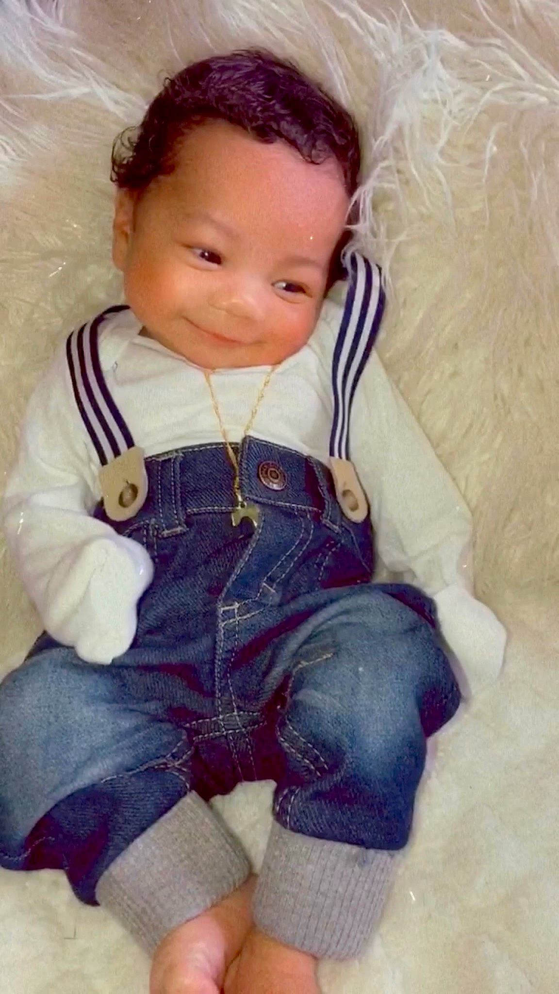 Cameron is registered to the contest to win money with this photo: baby, baby_products, baby_toddler_clothing, brown_hair, cheek, child, eye, face, forehead, head, joy, nose, overall, person, play, sitting, skin, toddler, toy