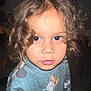 child, toddler, curly_hair, blue_sweater, cartoon_characters, face, eyes, lips, food, close_up, indoor, portrait, person, cute, young, looking, expression, hair, sweater, childhood