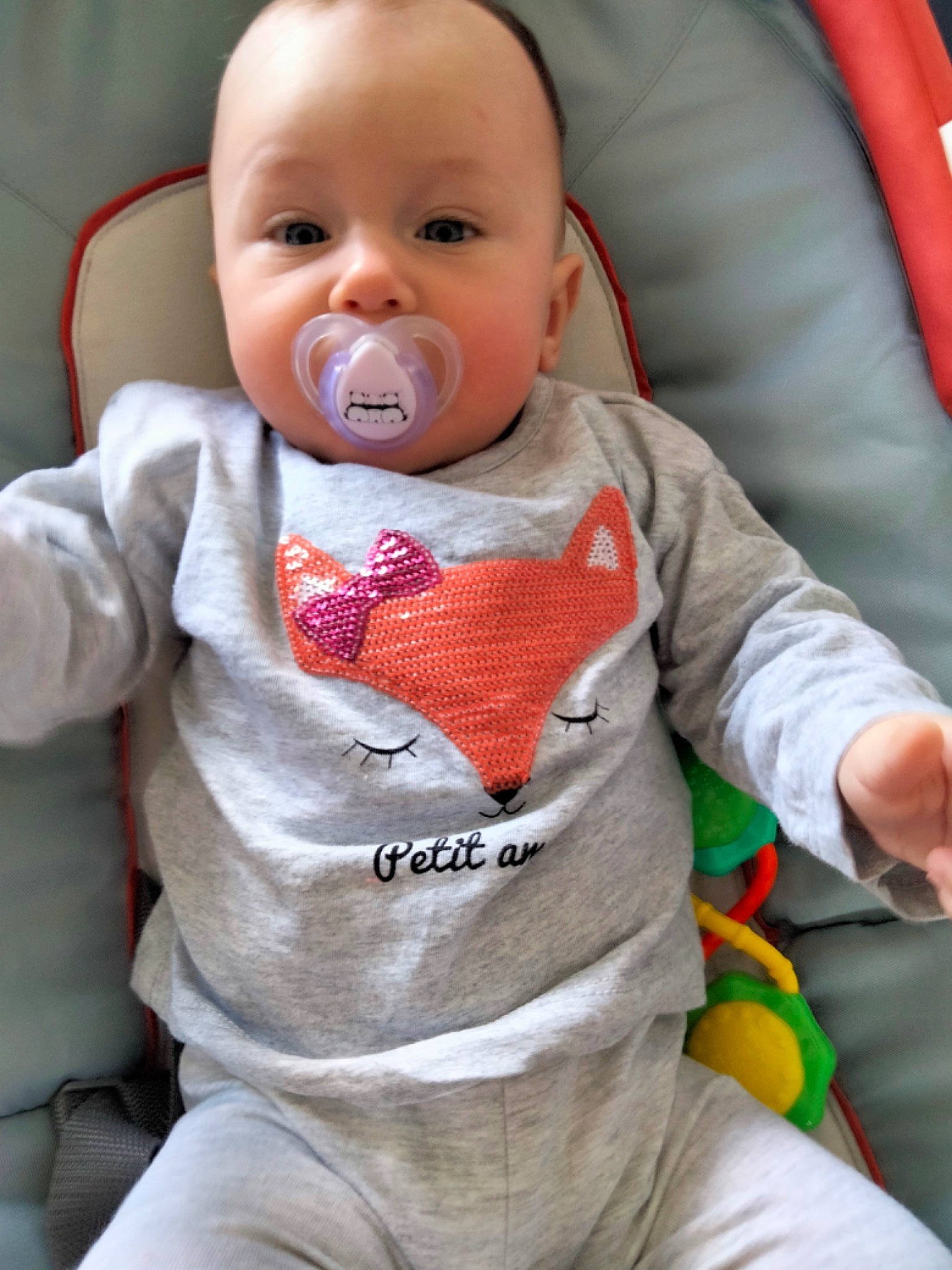 Inaya participe au concours pour gagner de l'argent avec cette photo : arm, baby, baby_toddler_clothing, cheek, comfort, eye, face, facial_expression, hand, head, human_body, neck, nose, orange, outerwear, person, product, skin, sleeve, textile