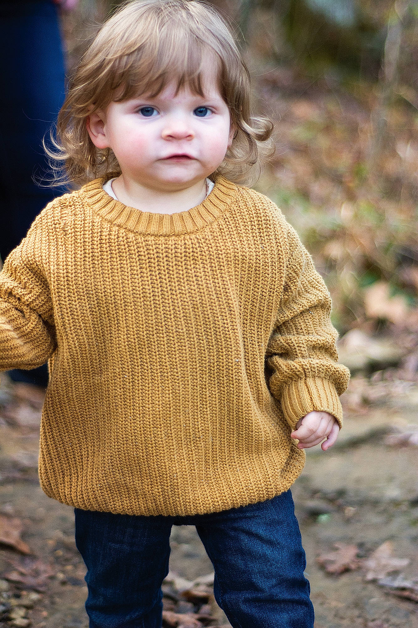 Clarence is registered to the contest to win money with this photo: baby_toddler_clothing, blond, cheek, cool, electric_blue, face, grass, happy, head, joint, pattern, people_in_nature, person, photograph, skin, sleeve, t_shirt, toddler, wood, wool