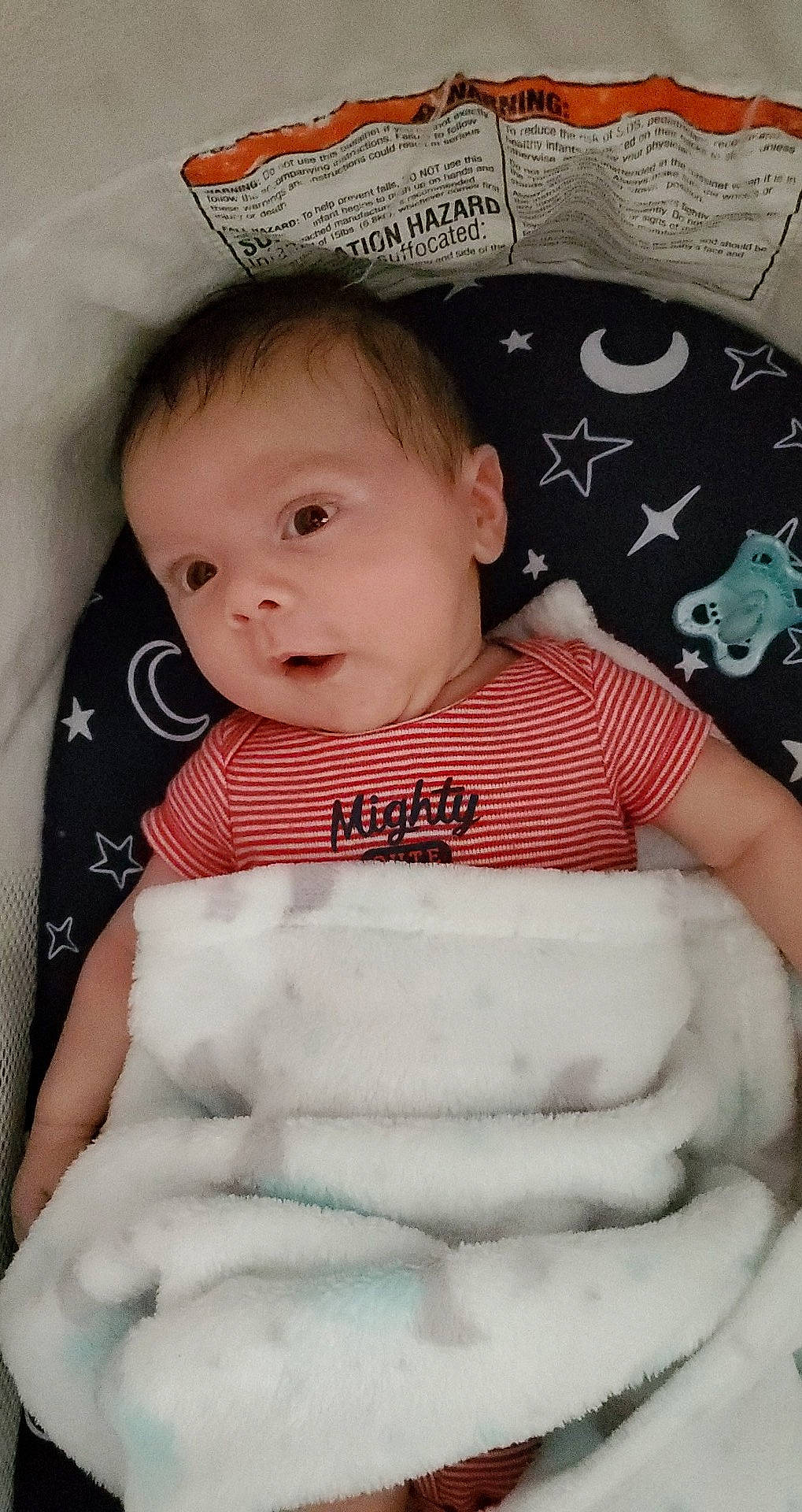 Isaiah is registered to the contest to win money with this photo: arm, baby, baby_safety, baby_toddler_clothing, cheek, child, comfort, eyebrow, facial_expression, finger, happy, linens, organ, pattern, person, product, sitting, skin, sleeve, textile