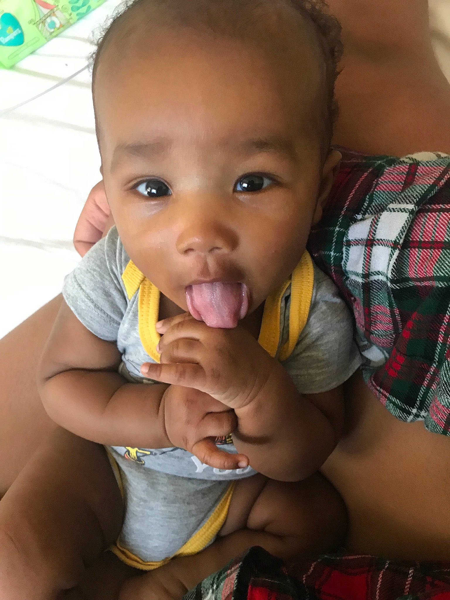 Camron is registered to the contest to win money with this photo: adaptation, baby, black, cheek, child, eating, eye, face, finger, fun, hand, head, lip, mouth, neck, nose, person, skin, smile, thumb