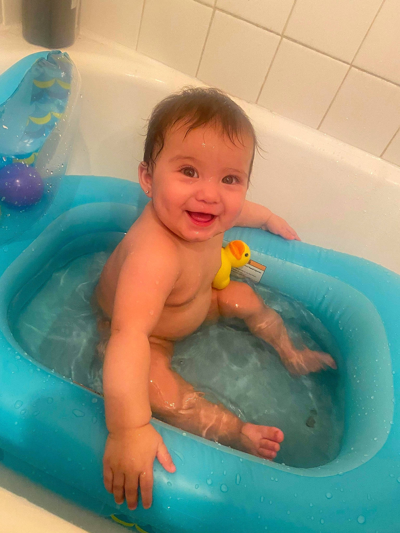 Camila joined the competition — help win amazing prizes! baby, baby_bathing, bath_toy, bathing, bathroom, bathtub, blue, child, fluid, fun, leisure, liquid, organ, person, personal_care, plumbing, skin, smile, thumb, toddler