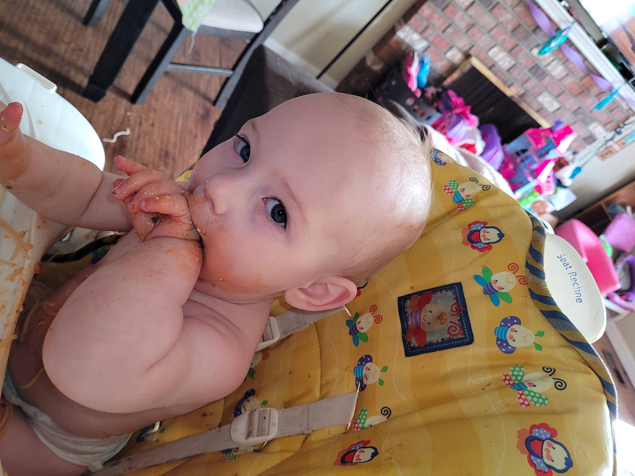 Rhea is registered to the contest to win money with this photo: baby, baby_products, baby_toddler_clothing, baby_toys, cheek, chest, child, eyelash, face, flooring, fun, happy, iris, nose, person, sitting, skin, thumb, toddler, toy