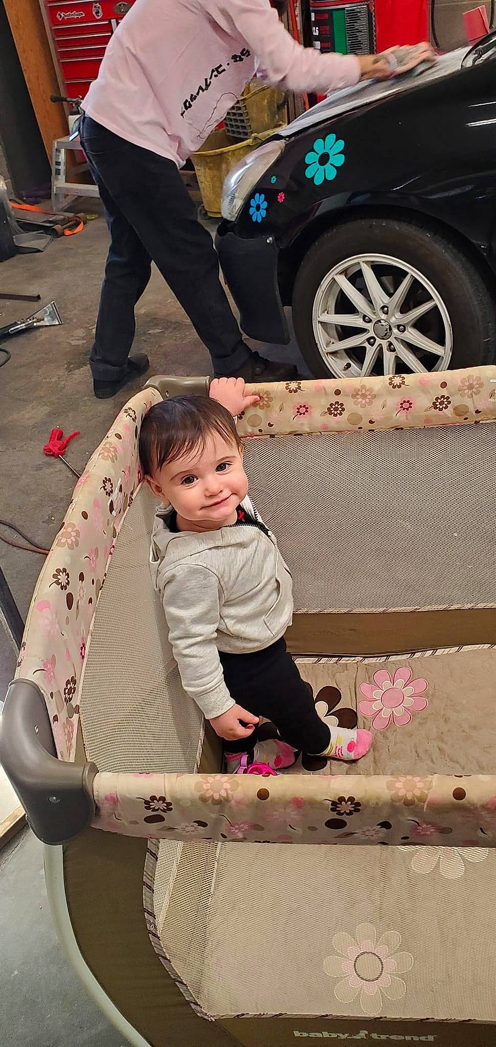 Elaine is registered to the contest to win money with this photo: alloy_wheel, automotive_design, automotive_lighting, automotive_tire, black, car, fender, hairstyle, hubcap, joy, motor_vehicle, person, photograph, pink, public_space, shoe, tire, toddler, vehicle, wheel