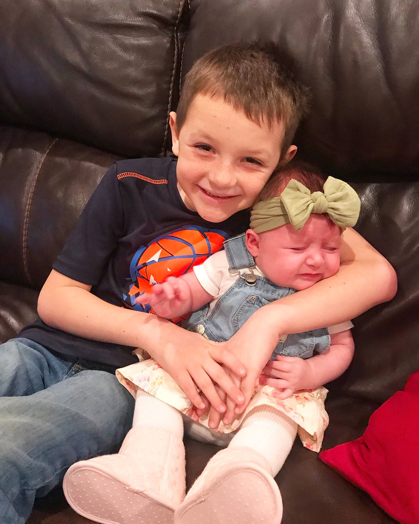 Kolt is registered to the contest to win money with this photo: ball, comfort, couch, eye, facial_expression, finger, hand, happy, headwear, human, interaction, joy, lap, leg, mammal, mouth, muscle, orange, person, skin