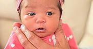 Valerie joined the competition — help win amazing prizes! adorable, baby, closeup, cute, expression, eyes, face, hand, headband, heart_pattern, holding, indoors, infant, newborn, person, pink_clothing, portrait, ring, skin, soft_light