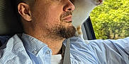 Jackson joined the competition — help win amazing prizes! man, cat, car, driving, shoulder, orange_cat, white_cat, window, seatbelt, shirt, beard, side_profile, nature, tree, daylight, interior, portrait, animal, pet, curious