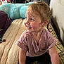 toddler, child, smile, braid, bed, blanket, plush_toy, indoor, happy, clothing, person, portrait, furniture, soft_toys, casual, cute, young_child, sitting, pink_shirt, black_pants