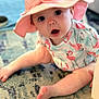baby, child, hat, pink, flamingo, pattern, sitting, rug, indoor, curious, wide_eyes, open_mouth, infant, cute, legs, foot, clothing, person, headwear, expression